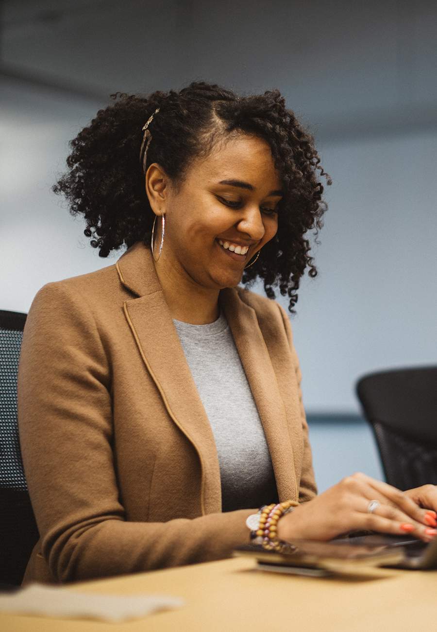 Woman smiling working on her laptop