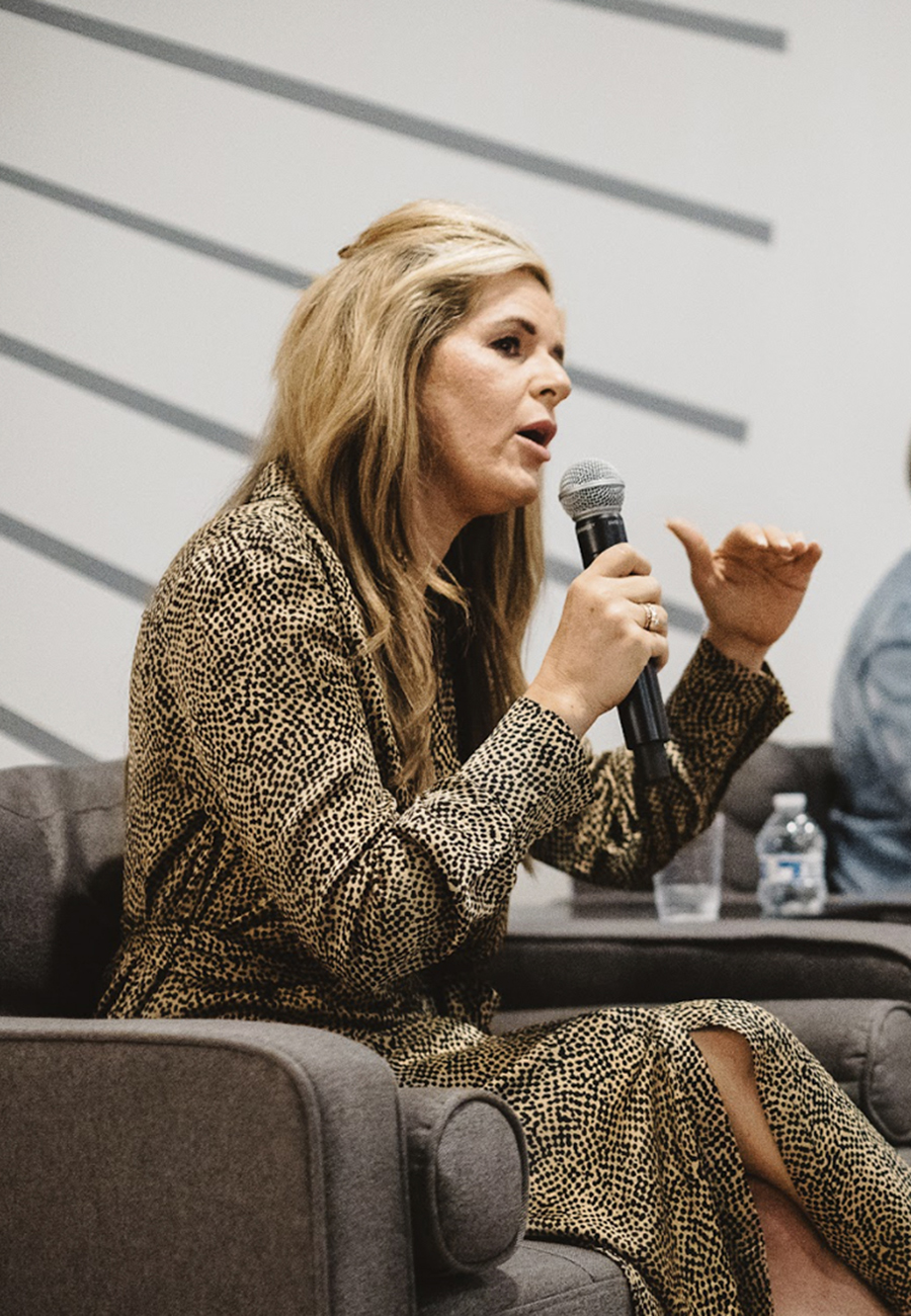 Woman speaking into a microphone at Nerdery's women in healthcare tech event