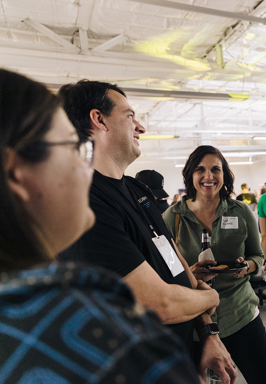 Three people at an event in Nerdery's AZ office space