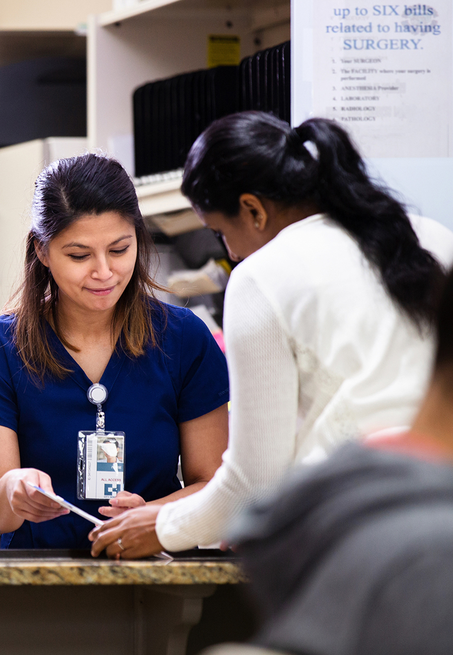 Nurse speaking to a woman at a surgery center